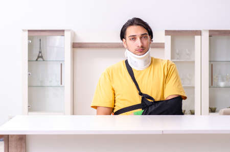 Young man after car accident suffering at homeの写真素材