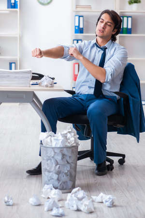 Businessman rejecting new ideas with lots of papersの写真素材