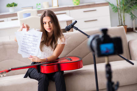 Female beautiful blogger playing guitarの写真素材