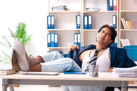 Employee coming to work straight from bedの写真素材