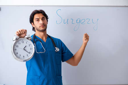 Young male doctor in front of whiteboard