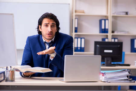 Young handsome businessman working in the officeの写真素材