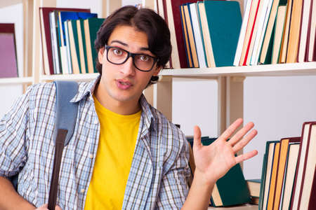 Male student preparing for exams at libraryの写真素材