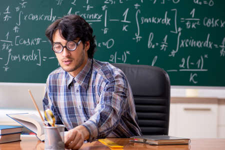 Funny male math teacher in the classroom