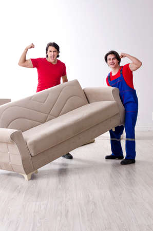 Two young contractor employees moving personal belongingsの写真素材