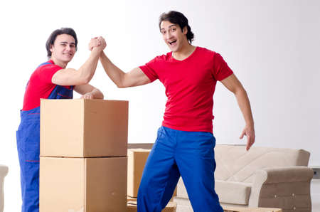 Two young contractor employees moving personal belongings