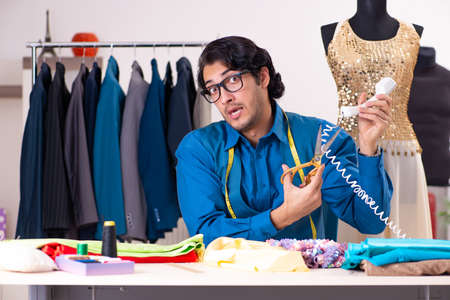 Young male tailor working at workshopの写真素材