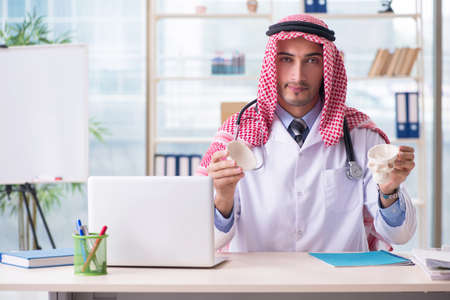 Arab doctor with humans skullの写真素材