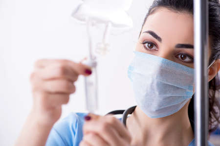 Young female doctor in infusion conceptの写真素材