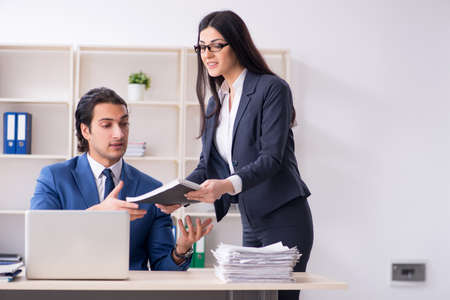 Two employees working in the officeの写真素材