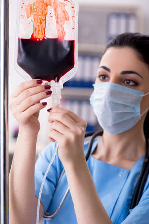 Young female doctor in infusion conceptの写真素材