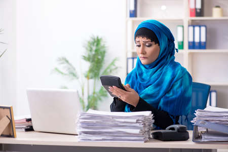 Female employee in hijab working in the officeの写真素材