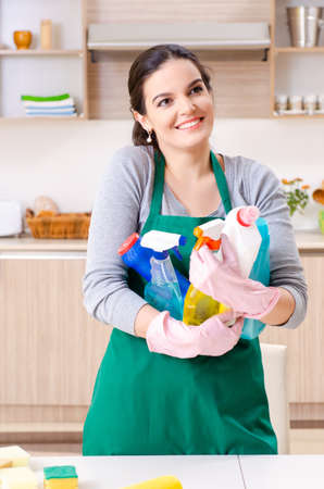 Young female contractor doing houseworkの写真素材