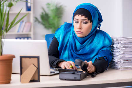 Female employee in hijab working in the officeの写真素材