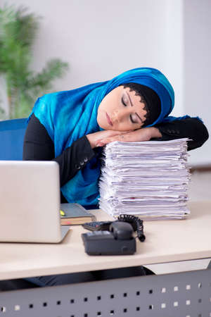 Female employee in hijab working in the officeの写真素材