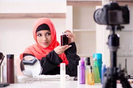Beauty blogger in hijab recording video for her blogの写真素材