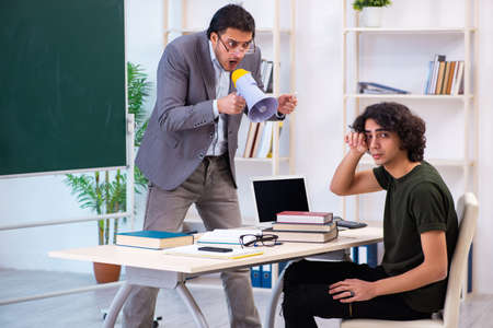 Young teacher and student in the classroomの写真素材