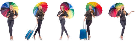 Woman with suitcase and umbrella isolated on whiteの写真素材
