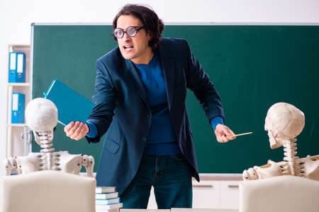 Male teacher and skeleton student in the classroomの写真素材