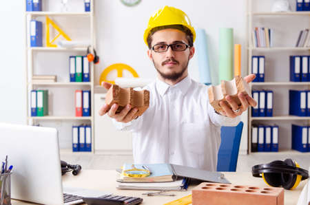 Young male architect working in the office