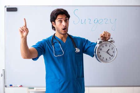 Young male doctor in front of whiteboardの写真素材