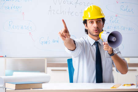 Young male architect in front of the whiteboard