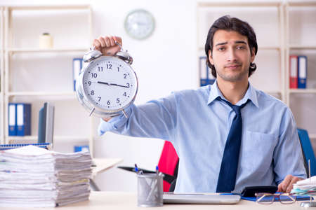 Young male businessman employee unhappy with excessive workの写真素材