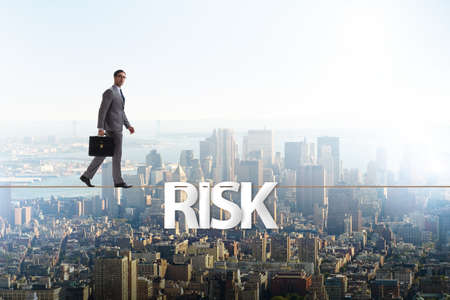 Businessman in risk concept walking on tight ropeの写真素材