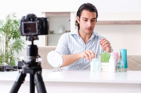 Young handsome man recording his blog in hygiene concept