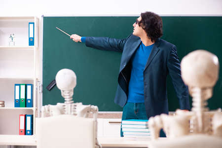 Male teacher and skeleton student in the classroomの写真素材