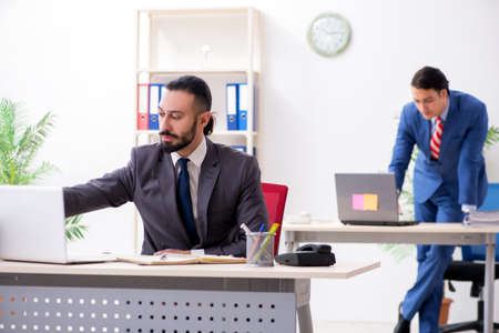 Two male colleagues in the officeの写真素材