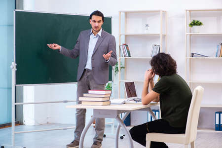 Young teacher and student in the classroom