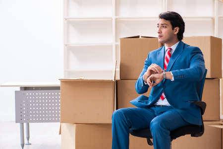 Young handsome businessman moving to new workplaceの写真素材