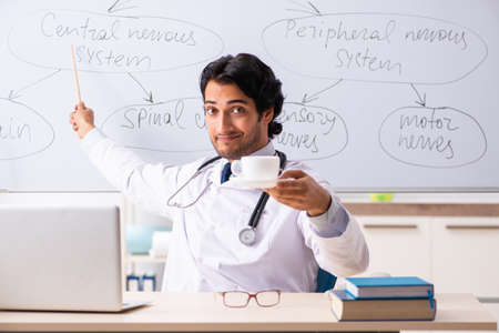 Young male doctor neurologist in front of whiteboardの写真素材