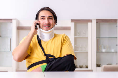 Young man after car accident suffering at homeの写真素材