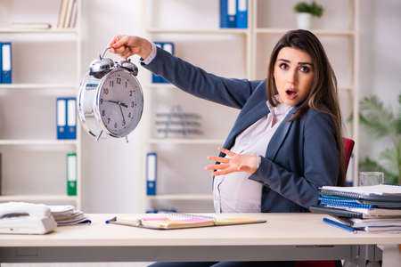 Young pregnant woman working in the officeの写真素材