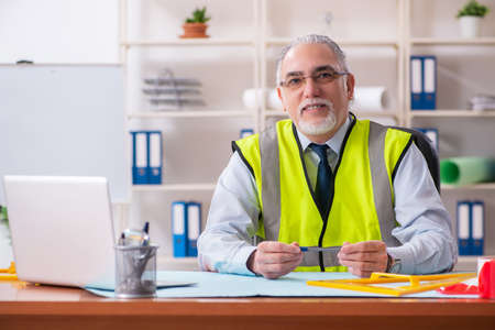Aged construction engineer working in the office