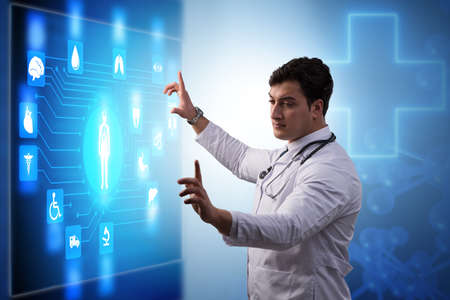 Doctor in telemedicine concept looking at screenの写真素材