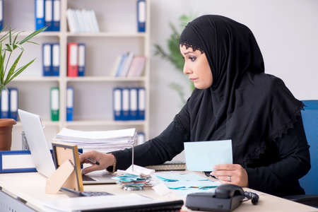 Female employee bookkeeper in hijab working in the officeの写真素材