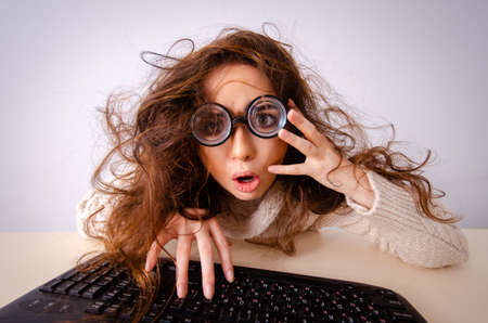 Funny nerd girl working on computerの写真素材
