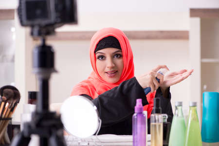 Beauty blogger in hijab recording video for her blogの写真素材