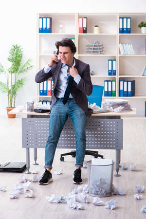 Businessman rejecting new ideas with lots of papersの写真素材