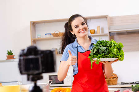 Young female vegetarian recording video for her blogの写真素材