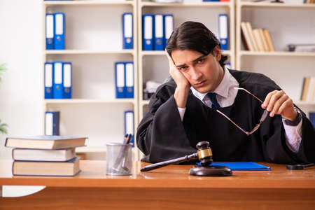 Young handsome judge working in courtの写真素材