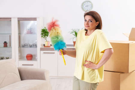 Middle-aged woman cleaning new apartment