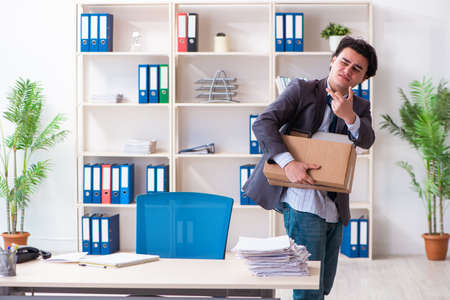 Young male employee being fired from his workの写真素材