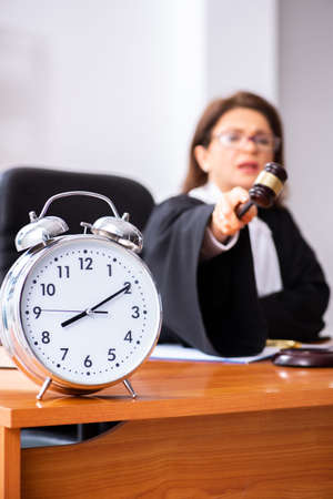 Middle-aged female doctor working in courthouseの写真素材