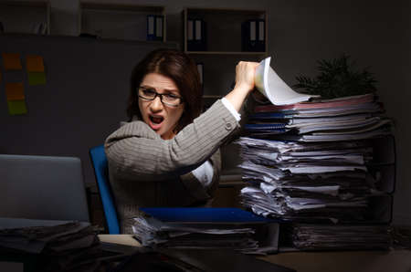 Female employee suffering from excessive workの写真素材