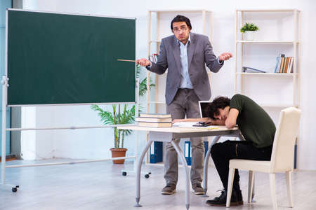 Young teacher and student in the classroomの写真素材