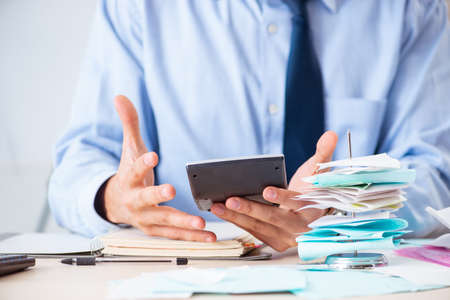 Young handsome businessman in budget planning concept